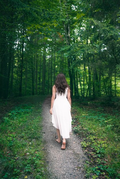 Rear view of woman walking in forest