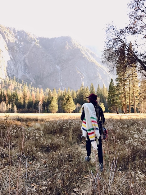 Rear view of woman walking in forest