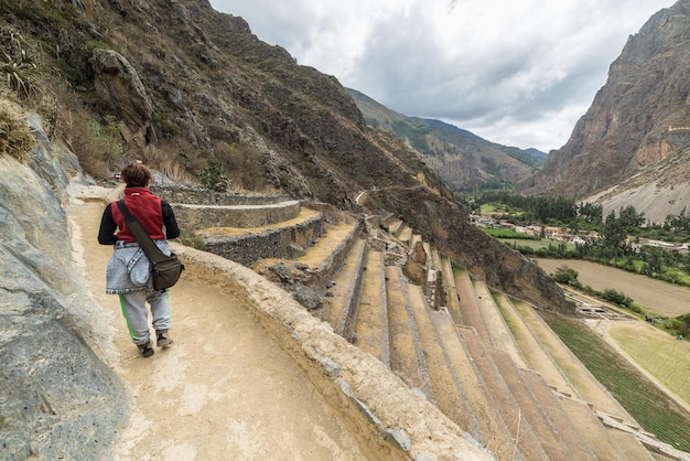 Rear view of woman walking on pathway on mountain