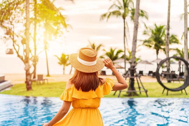 Photo rear view of woman wearing hat swimming pool