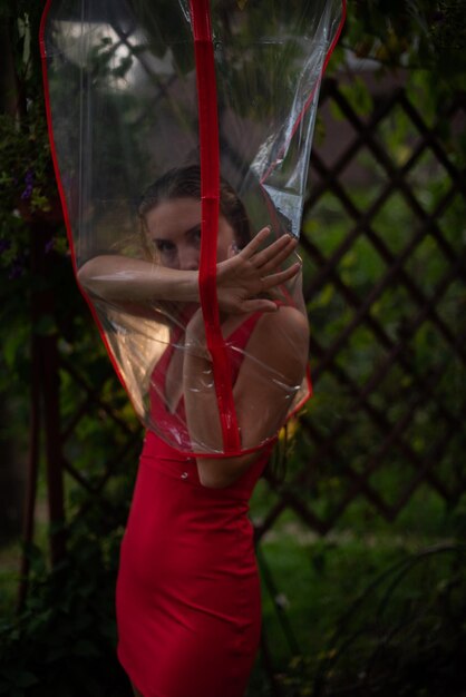 Rear view of woman with arms raised standing in a bag for clothes