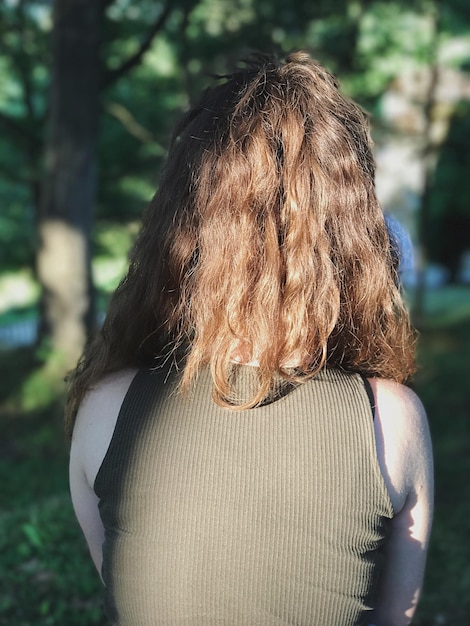 Rear view of woman with brown hair at park