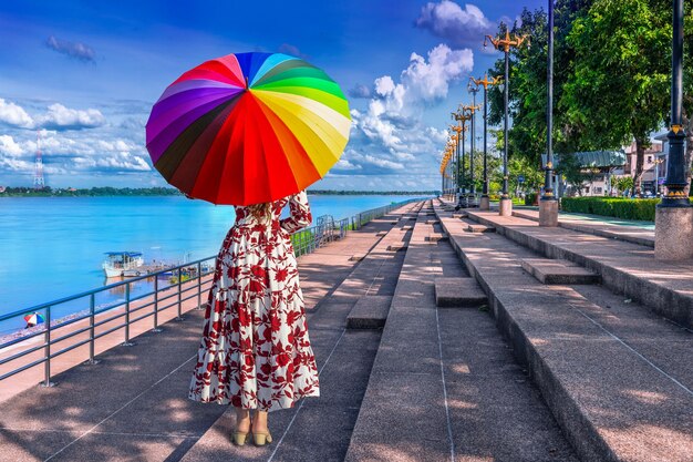 Photo rear view of woman with multi colored umbrella against sky