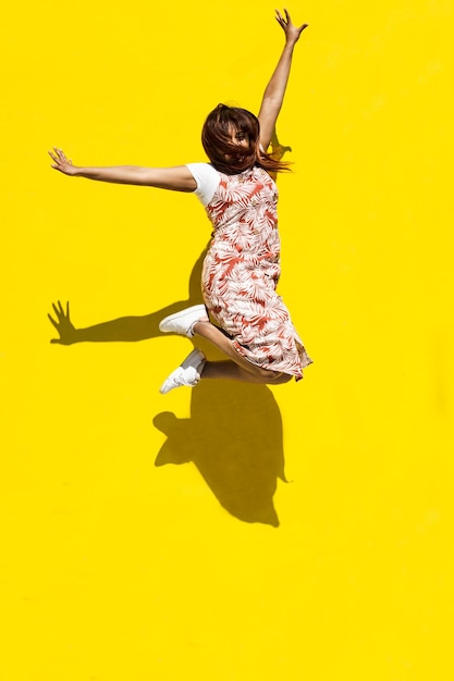 Rear view of woman with yellow umbrella