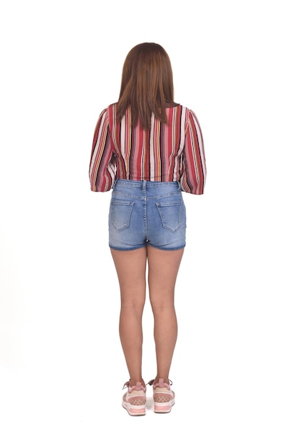 Rear view of a women with shorts and sneakers on white background