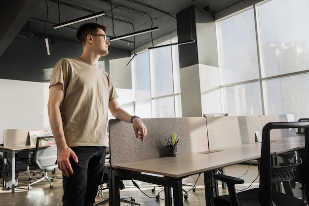 Rear view of young man using mobile phone while standing in cafe