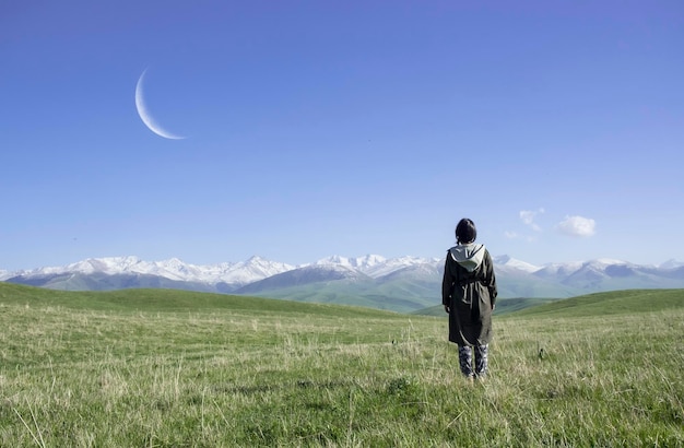 Rear view of young woman looking at mountains