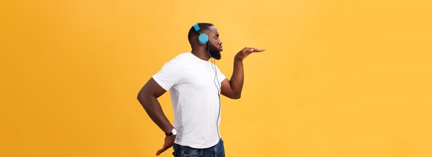 Rear view of young woman standing against yellow background