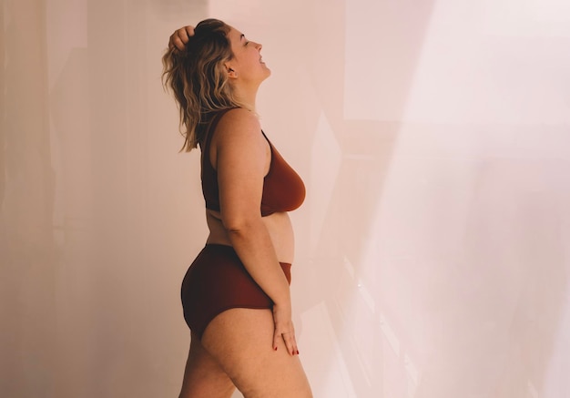Rear view of young woman standing at home