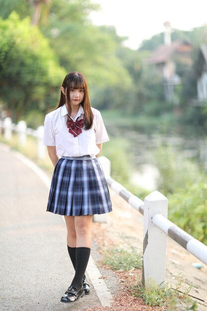 Rear view of young woman walking on road