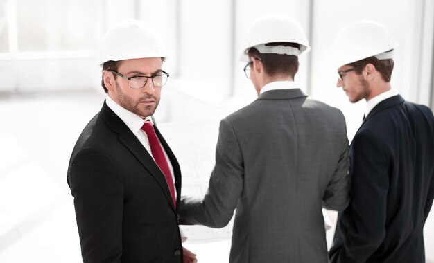 Rear viewbusinessman and architects standing in the new office