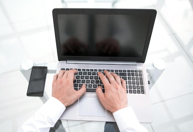 Rear viewbusinessman typing on a laptop