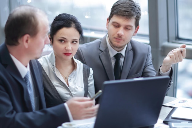 Rear viewgroup of business people using laptop in office