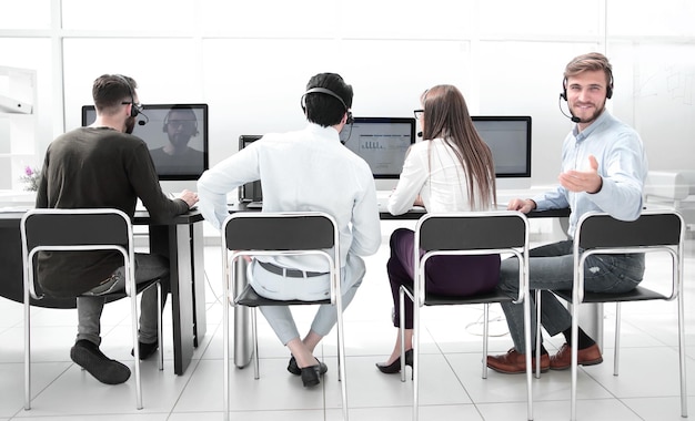 Rear viewthe operators of the business center sitting at a Desk