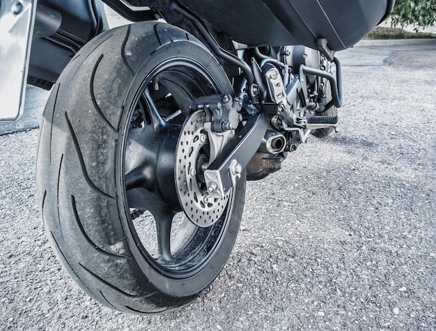 Rear wheel of motorcycle on asphalt