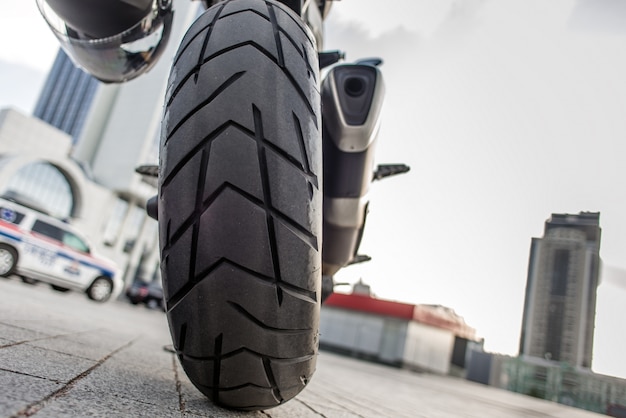 Rear wheel of Red motorcycle in the city street