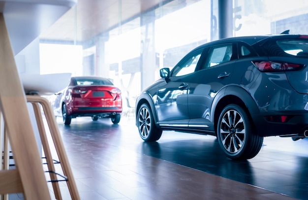 Rearview car parked in luxury showroom Car dealership office New car parked in modern showroom Auto