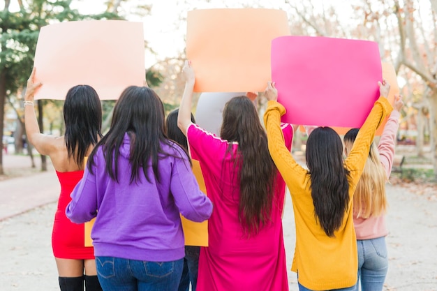 Rearview multiethnic group demonstration with signs and banners international womens day