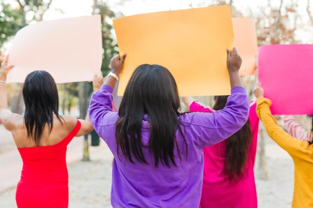 Photo rearview multiethnic group demonstration with signs and banners international womens day