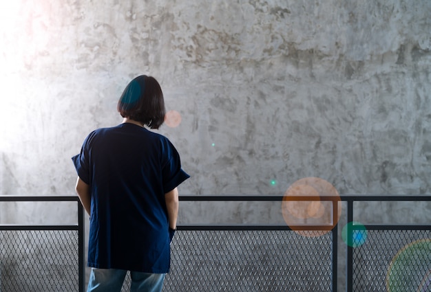 Rearview of shot hair lady in casual blue outfit