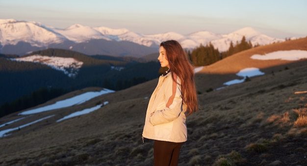 Rearview shot of a young female hiker enjoying the view from the top of a mountain