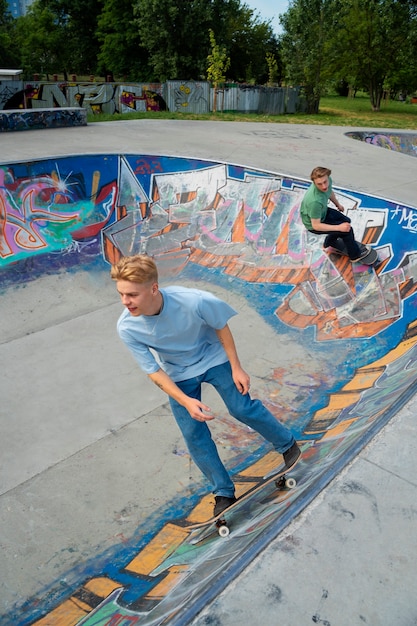 Foto skater adolescente ribelle che si diverte nello skate park