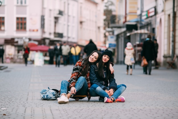 rebellious girls sitting on the street