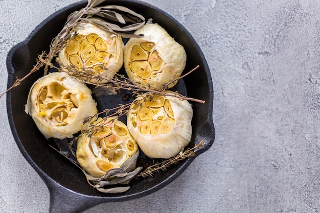 Recept voor geroosterde knoflookpasta gemaakt met kruiden in gietijzeren koekenpan.