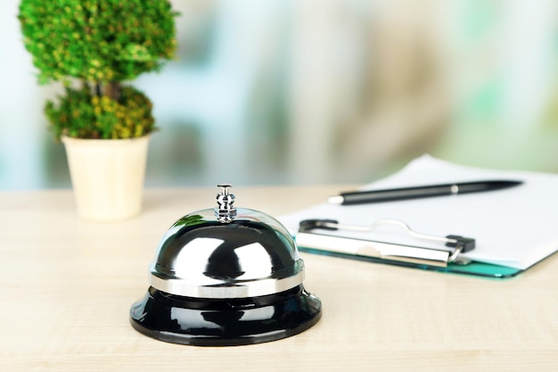 Photo reception bell on desk on bright background