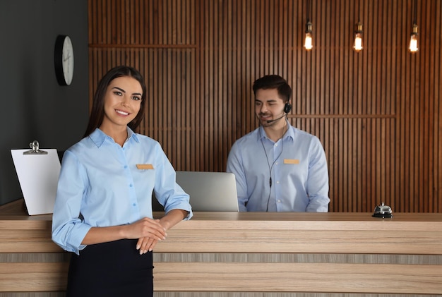 Receptionist at desk with colleague in lobby