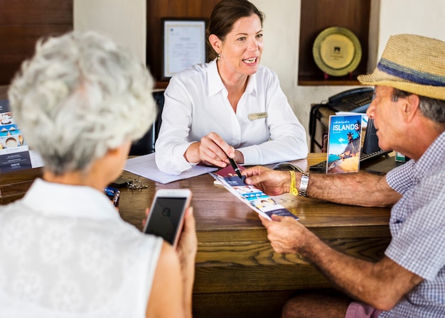 Receptionist giving explanations to a senior man