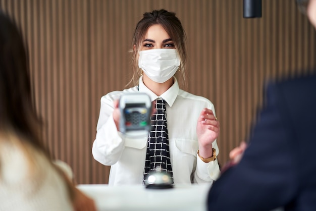receptionist in mask working in a hotel