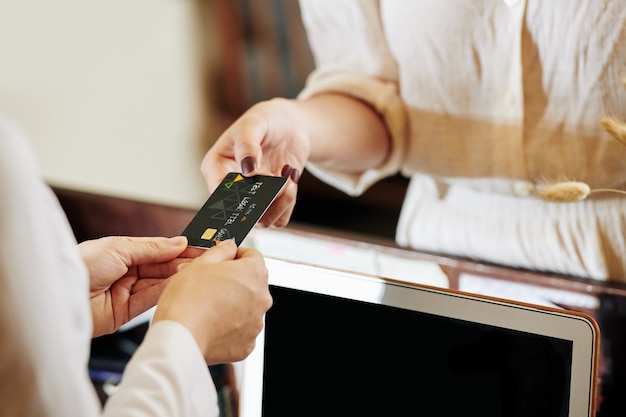 Photo receptionist returning credit card