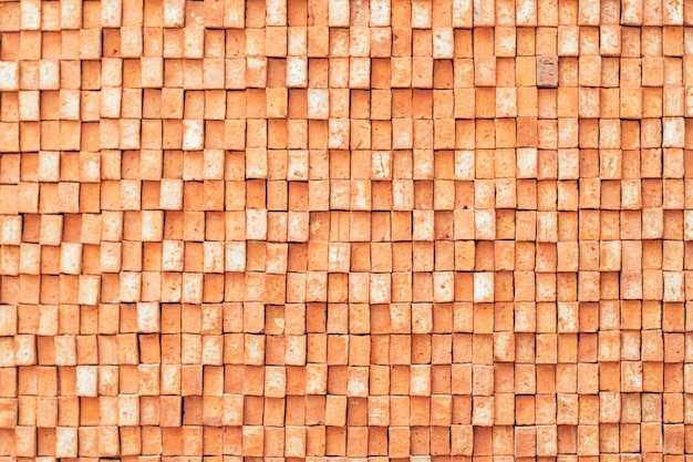 Rechthoekige oranje bakstenen willekeurig patroon muur gevel textuur materiaal in architectuur exterieur en interieur