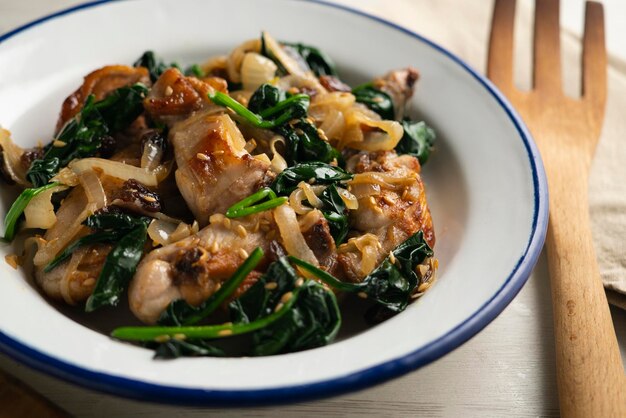 Photo recipe for fried rabbit with spinach and raisins traditional tapa from northern spain