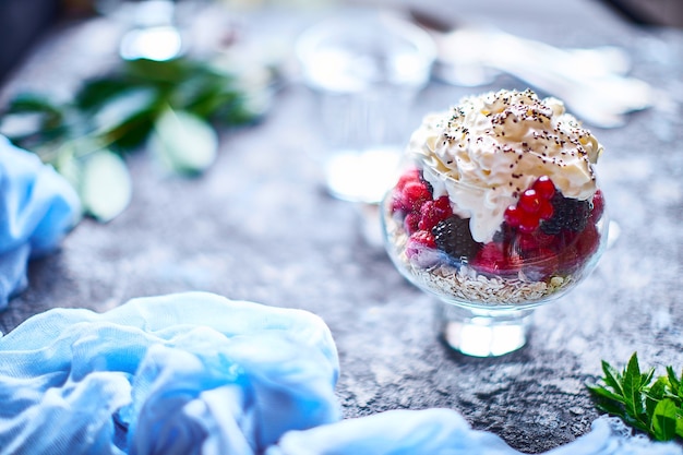 Recipe ideas for summer diet breakfast, healthy morning dessert in portioned jars with summer berries - raspberry, cherries, blackberry. 