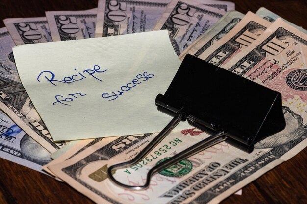 Photo recipe for success sticky note on dollars money