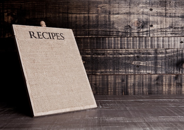 Recipes wooden board for kitchen on wooden table