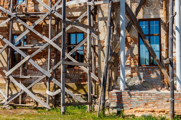 Photo reconstruction of old building with old wooden scaffolding
