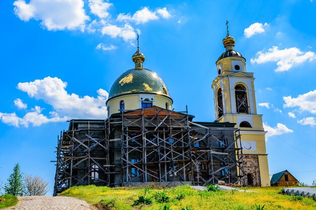 Reconstruction of the old orthodox church in ukrainian countryside. Wooden scaffolding