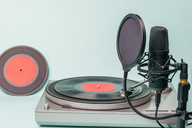 A record player with red vinyl discs and a modern microphone.