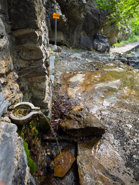 ギリシャの山の峡谷のハイキングコースの水源の高原の下のレクリエーションエリア