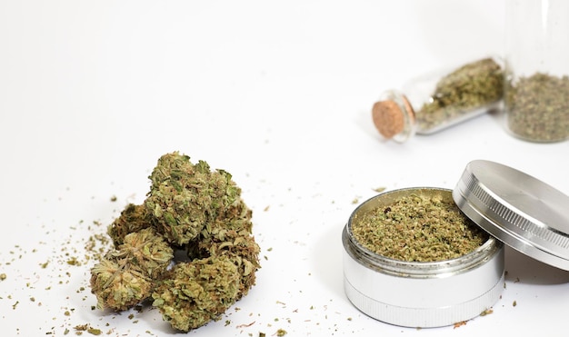 recreational marijuana buds grinder glass bottle isolated on white background