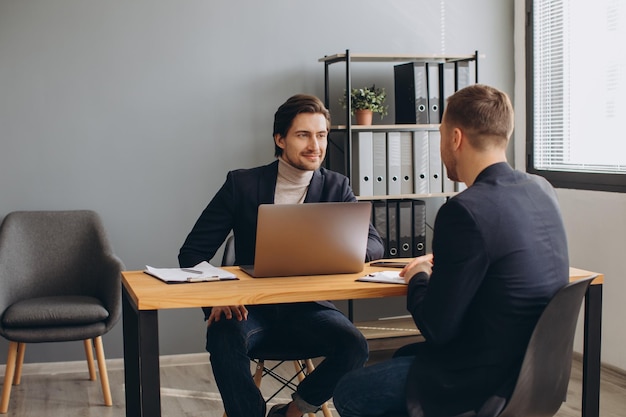 Recruiter during business job interview in office with male candidate