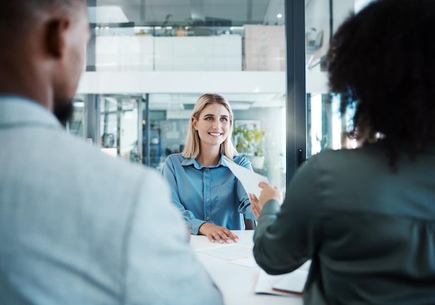 Recruitment job interview or business people in meeting for hiring feedback or documents review in office Happy smile or HR women with paper for contract sign consulting or startup teamwork