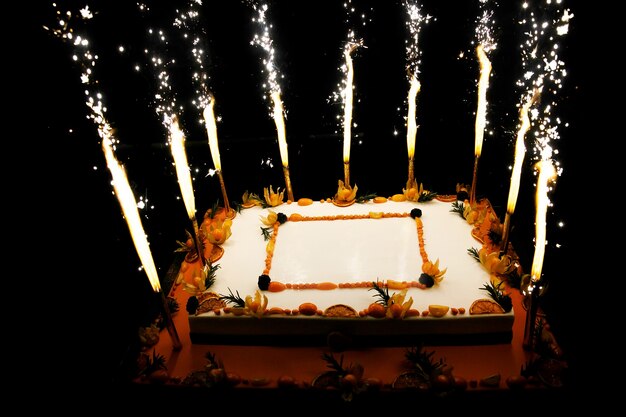 Rectangular Birthday fruit cake with fireworks candles