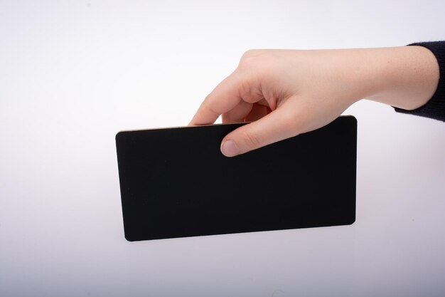 Rectangular shaped black notice board in hand