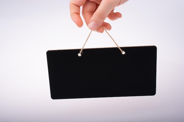 Photo rectangular shaped black notice board in hand