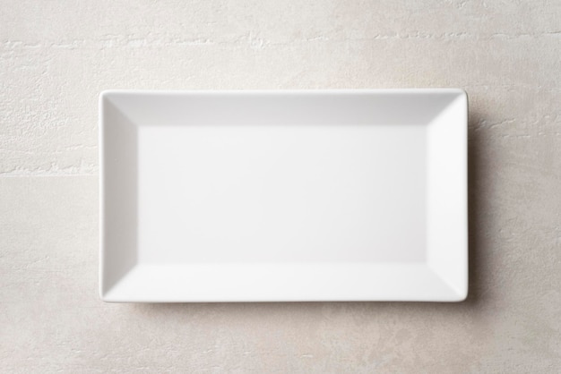 Rectangular white plate on a light stone background