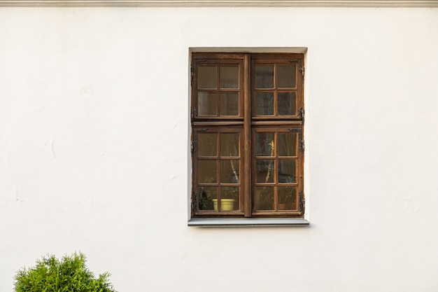 Rectangular wooden window in white wall